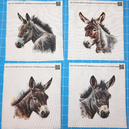 Four prints of donkey faces on a blue grid background fabric