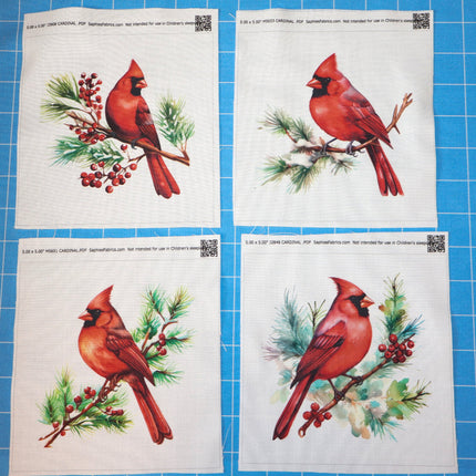 Four sheets of paper with red cardinal bird fabric panels