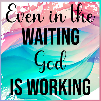 A fabric panel with a printed phrase 'Even in the WAITING God IS WORKING' on a multicolored background.