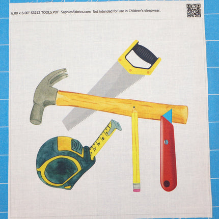 Colorful illustration of tools including a hammer, saw, and tape measure fabric panel